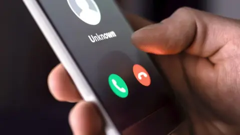 Getty Images Hand holding mobile phone