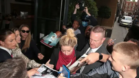 Getty Images Amber Heard is mobbed by fans upon arrival at her hotel after an appearance at the Royal Courts of Justice, Strand on July 24, 2020 in London, England