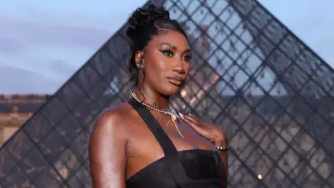 Victor Boyko/Getty Images Aya Nakamura attends the Lancome X Louvre photocall as part of Paris Fashion Week on September 26, 2023