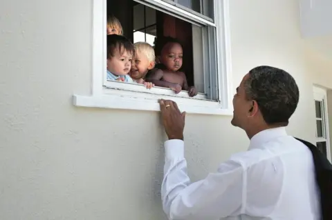 Pete Souza Obama looks through a window