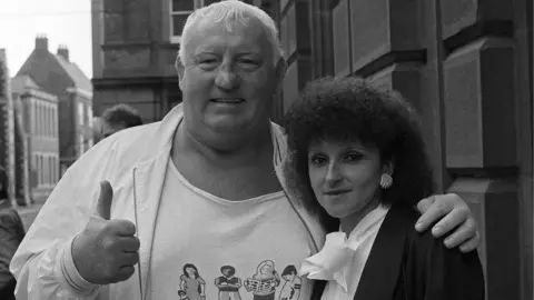 PA Big Daddy lends moral support to Fiona Kirk at the inquest into her husband Mal 'King Kong' Kirk's death