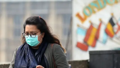 Getty Images A woman wears a mask in central London