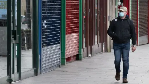 Getty Images man walking in mask