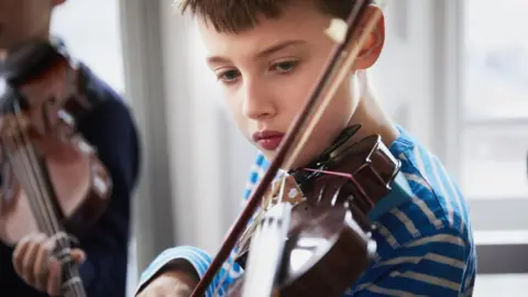 Getty Images boy playing violin