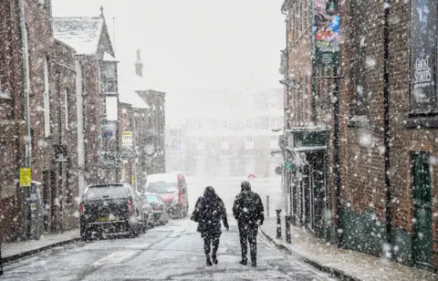 Shutterstock A snow shower falls in York city centre on 8 February 2021