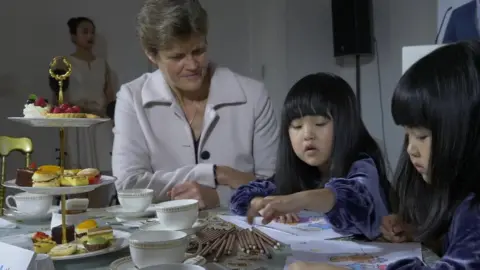 Huw Evans picture agency Dame Barbara Woodward, British ambassador to China, with twins Mi Ni and Mi Ai