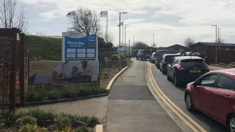 Cars queue outside Trecco Bay Holiday Park