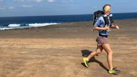 Beth Rainbow Ms Rainbow running on a beach