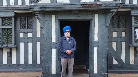Sandwell Council Councillor Charn Singh Padda outside the Oak House Museum.