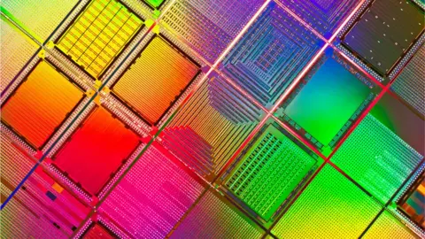 Getty Images Silicon wafers are seen this extreme-close-up file photo, shimmering in a rainbow of colours