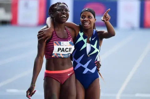 AFP South Africa's Prudence Sekgodiso (R) and Benin's Noelie Yarigo Pace (L) wait for their times on the digital board after competing in the women's 800m event during the Kip Keino Classic, part of the World Athletics Continental Tour 2022, at the Kasarani stadium in Nairobi.