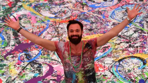 British artist s giant painting raises 45m for children s charities