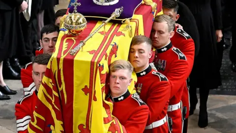 Reuters Pallbearers carrying the Queen's coffin