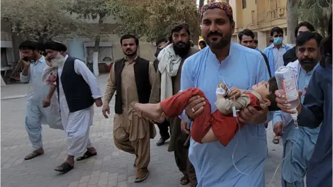 EPA People shift an injured victim, after a 5.9 magnitude earthquake with a shallow depth of nine kilometres struck Harnai, to a hospital in Quetta, Balochistan province, Pakistan, 7 October 2021.