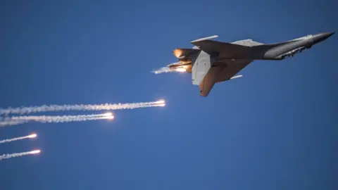 Getty Images A file photo of a J-16 fighter jet performing in the sky during the Chinese People's Liberation Army Air Force Aviation Open Day