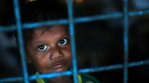 Reuters A Rohingya refugee boy, who crossed the border from Myanmar this week, takes shelter at Long Beach Primary School, in the Kutupalong refugee camp, near Cox's Bazar, Bangladesh October 23, 2017.