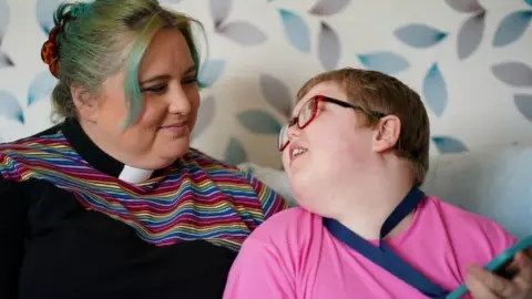 PA Media The Reverend Charlotte Cheshire with her son Adam Cheshire at their home in Newport, Shropshire