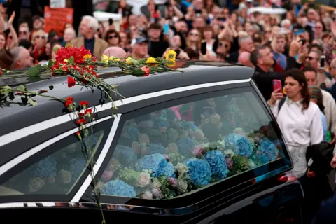 PA Media The funeral cortege of Sinéad O'Connor in Bray, Ireland, on 8 August 2023