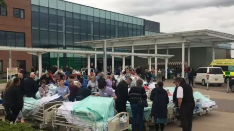 PAUL BRADBURY Patients outside the Stoke hospital after being evacuated.