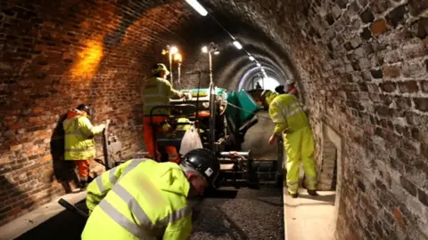 Lake District National Park Authority Workmen busy inside the trail's tunnel