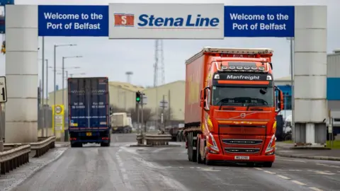 PA Media Freight lorries travelling through the Port of Belfast