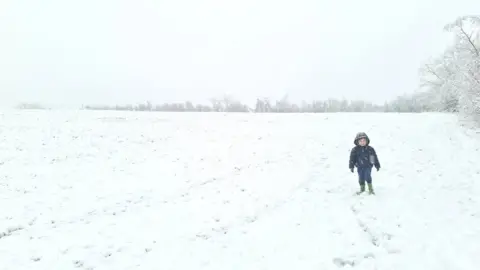 Craig M/Weather Watchers Child walking in thick snow