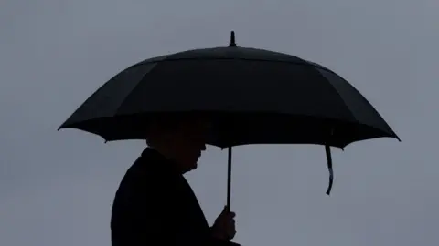 Getty Images Trump under umbrella