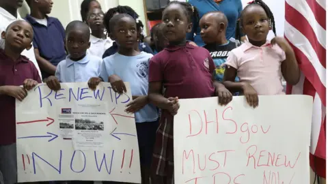 Getty Images Children protest the end of TPS in Miami