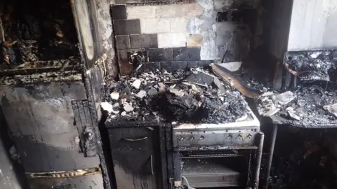 TWFRS A burnt out cooker with damage to surrounding cupboards