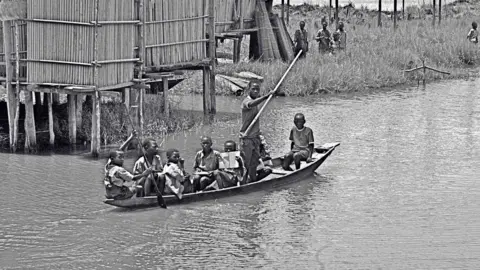 Sunmi Smart-Cole A photo by Sunmi Smart-Cole entitled: "School bus" boat in the Niger Delta, Nigeria