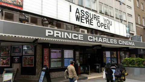 Getty Images A cinema in London told passers-by in May "I assure you we're open"