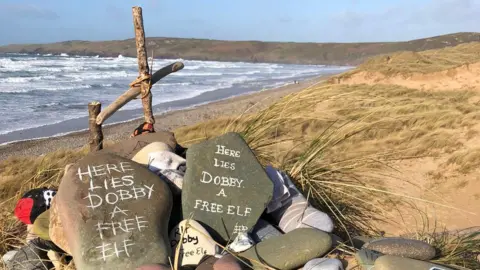 Pebbles and grave stone at Freshwater West