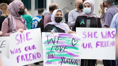 Getty Images Friends of Yumna Afzaal show their support at a vigil for her and her family