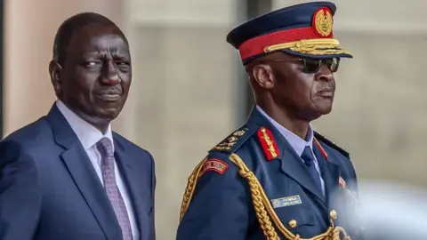 AFP William Ruto (L) and Chief of Kenya Defence Forces General Francis Ogolla (R) look on while inspecting a guard of honour by members of the Kenya Defence Forces (KDF) during his official state visit to State House in Nairobi, on February 28, 2024.