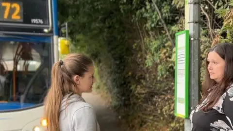 Emily and Clare Sheterline by a bus