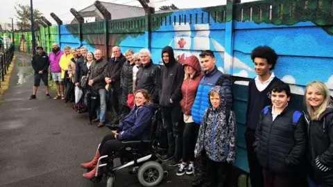 Ceredigion County Council People standing in front of Teifi riverside mural