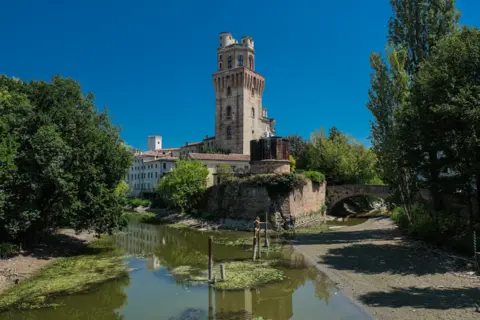 NurPhoto/Getty Images A tributary of the Bacchiglione di Padova, with the Specola in the background, Padua, Italy.