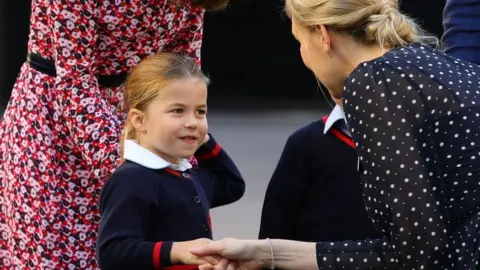 PA Princess Charlotte shakes hands with the head of the lower school