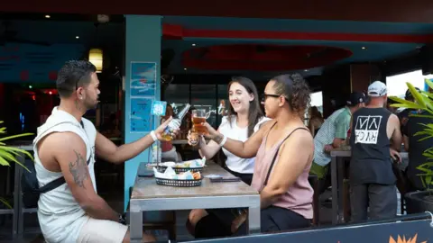 Getty Images A group of drinkers at a pub in Darwin