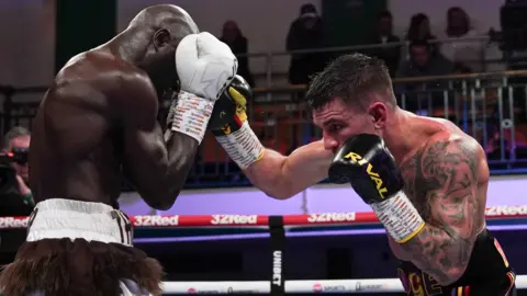 Yvan Mendy covers up from a shot from Sam Noakes