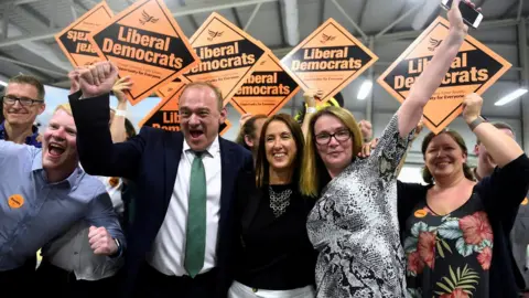 Reuters Jane Dodds (centre) celebrates her by-election victory with Lib Dem leader Sir Ed Davey and Kirsty Williams in 2019