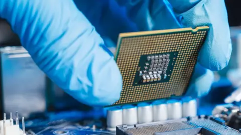 Getty Images CPU being placed in a motherboard.