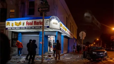 Reuters Businesses were looted on Tuesday night