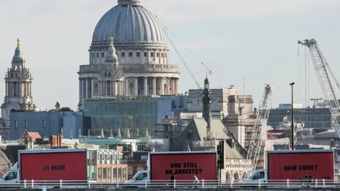 Jeff Moore/Justice4Grenfell The three vans with the billboards passing over a bridge near St Paul's Cathedral