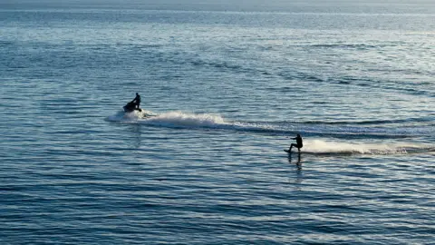 Photofusion | Getty Images Jet ski and water-skier