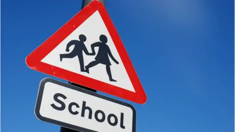 Getty Images School children crossing sign