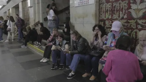 AFP Kyiv residents take shelter in a metro station
