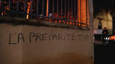 Getty Images The phrase meaning "insecurity kills" spray-painted on a wall of the higher education ministry in Paris