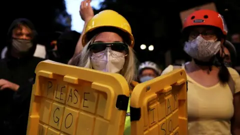 Reuters Members of the 'Wall of Moms' protest in Portland, Oregon, on 21 July 2020