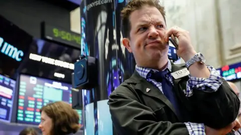 Reuters Traders work on the floor of the New York Stock Exchange (NYSE) in New York, U.S., October 12, 2018.